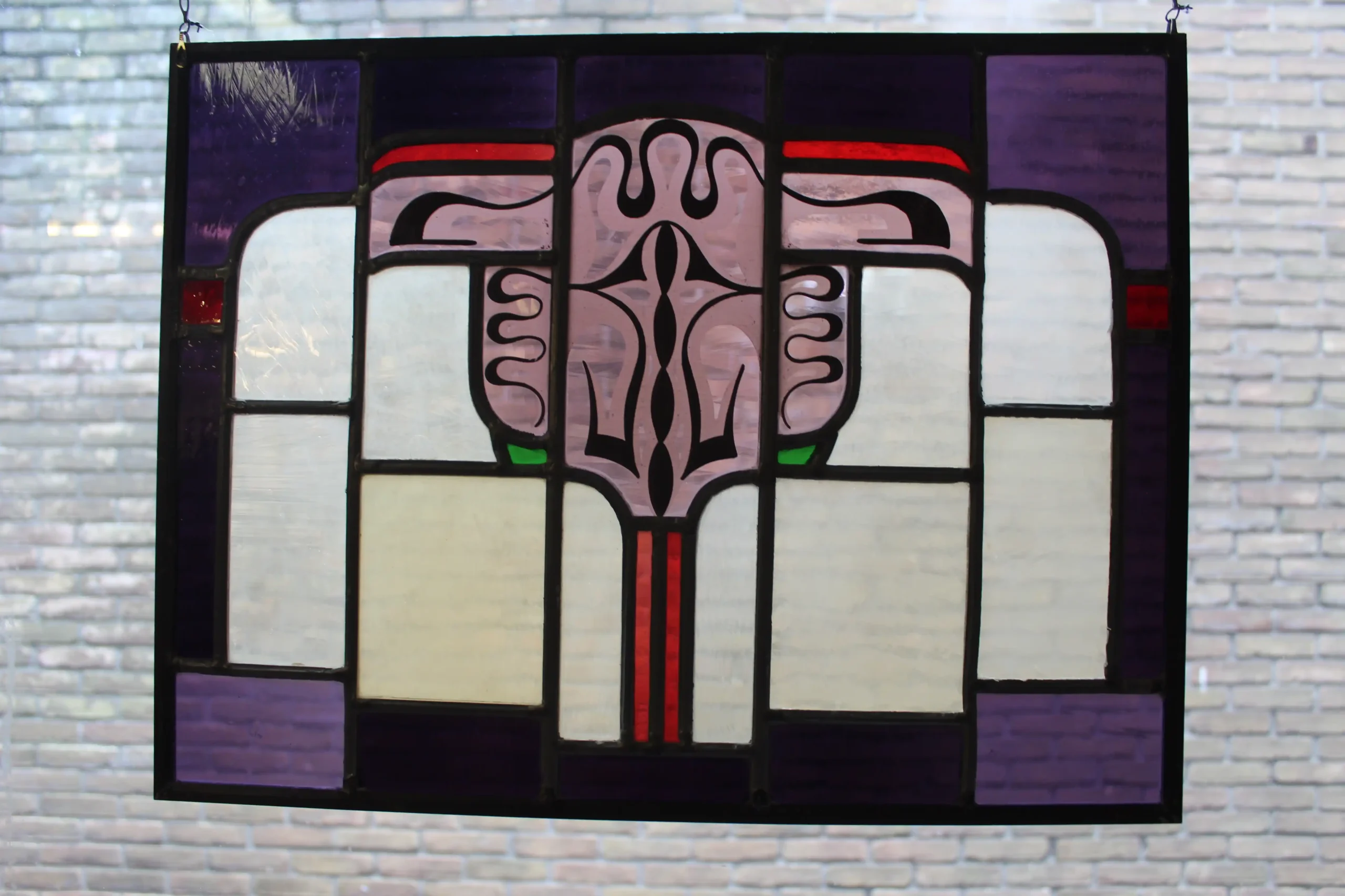 Twee Amsterdamse school glas in lood ramen